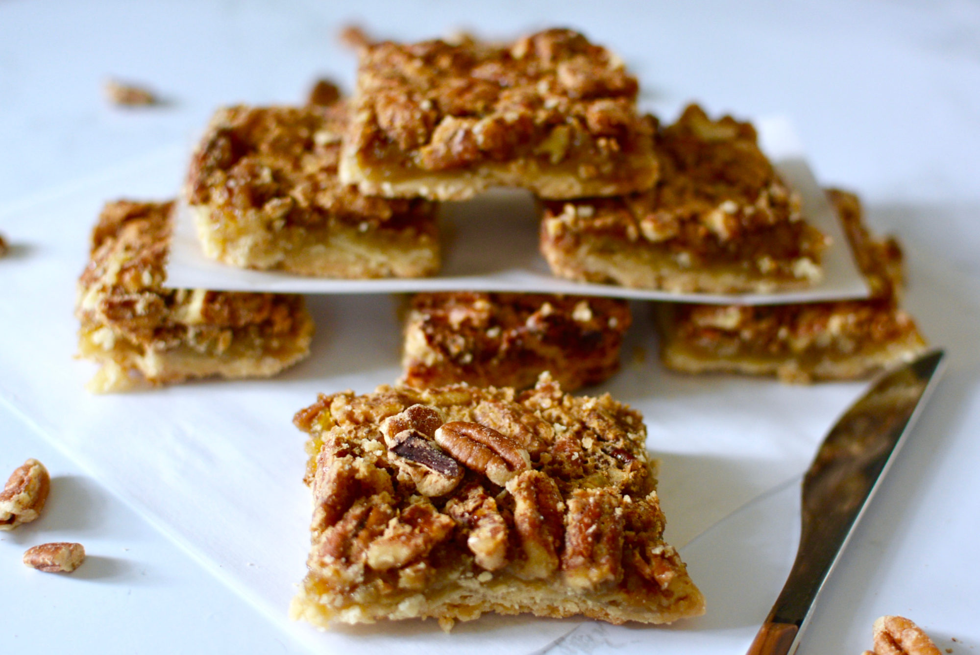 Pecan pie bars stack with butter knife