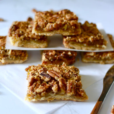 Pecan pie bars stack with butter knife