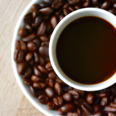 coffee cup with coffee beans on a saucer