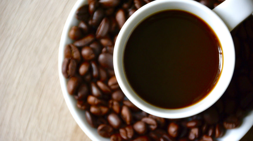 coffee cup with coffee beans on a saucer