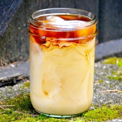 gingerbread iced latte on pavement with moss