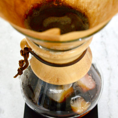 flash-chilling iced coffee with plants in background