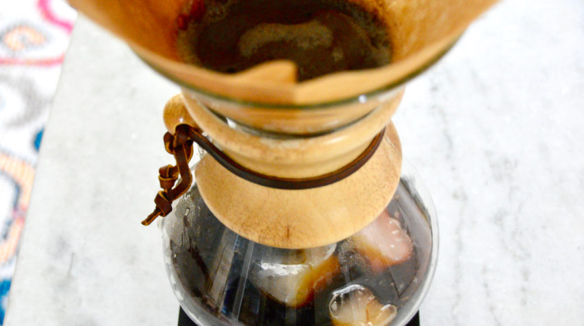 flash-chilling iced coffee with plants in background