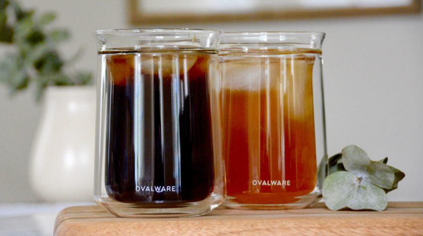 Ovalware clear tasting cups, one filled with cold brew and one filled with iced chai tea