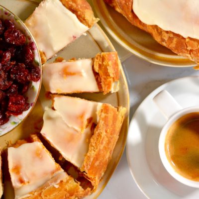 kringle or danish on a plate with coffee