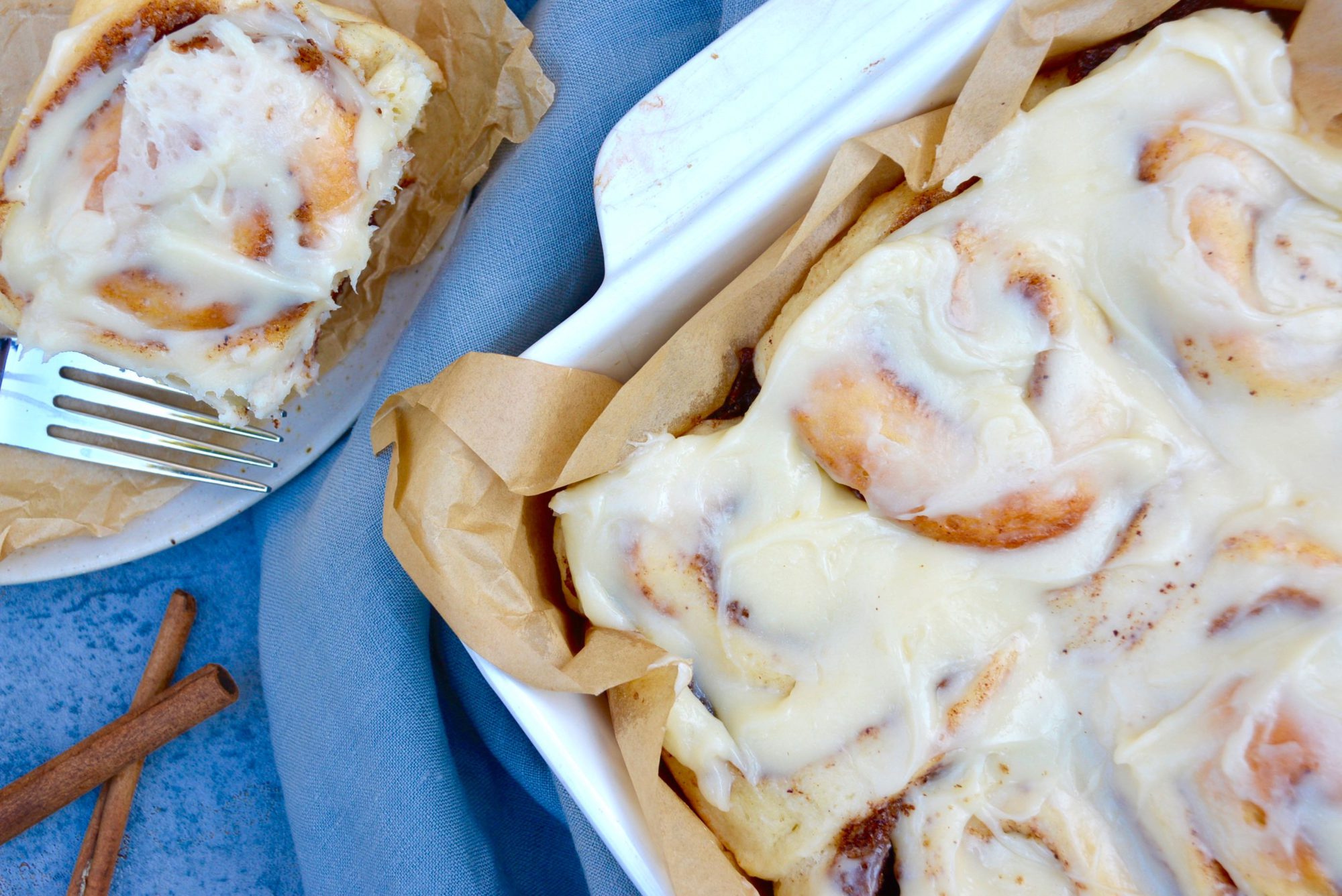 flat lay cinnamon rolls on blue background