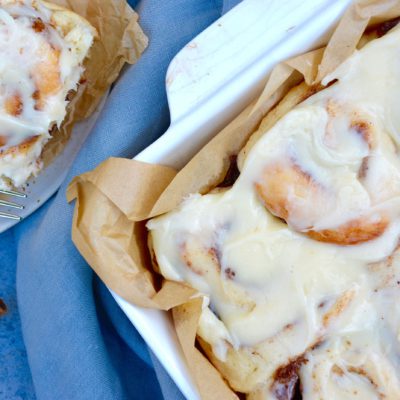 flat lay cinnamon rolls on blue background