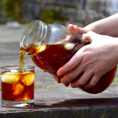 pouring cold brew into a glass