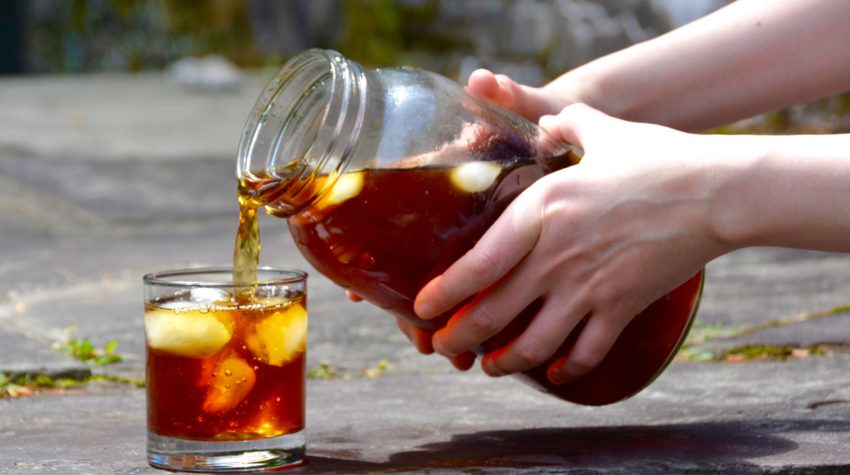 pouring cold brew into a glass