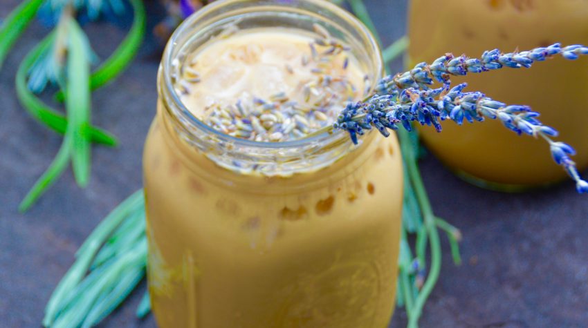 iced honey lavender latte in a mason jar outside