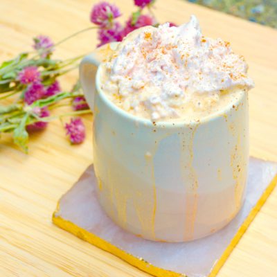 pink mug with strawberry coffee latte and pink dried flowers