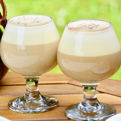 Vietnamese egg coffee in mini glasses on a wooden table